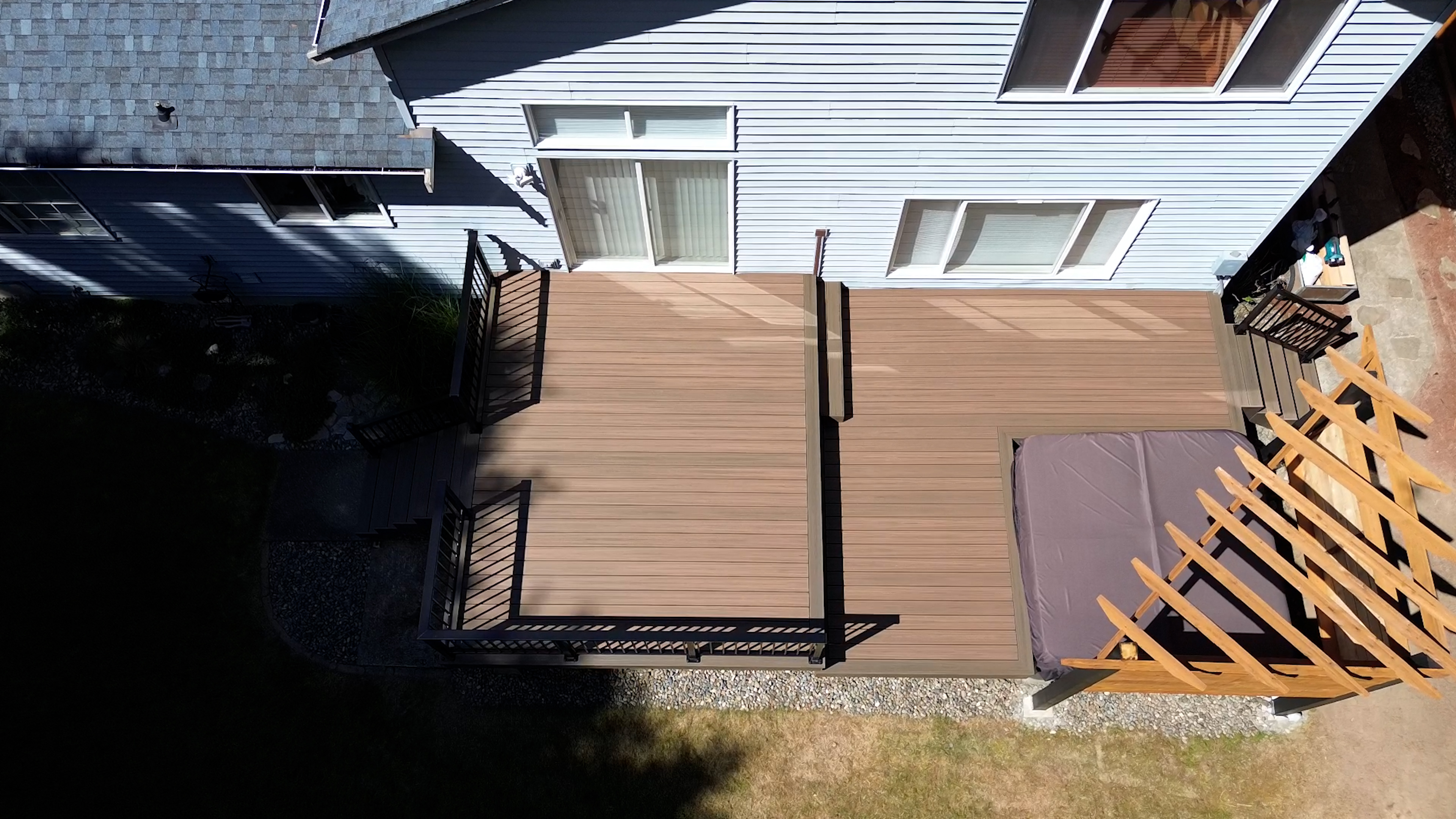View of hot tub area under custom pergola on Trex deck