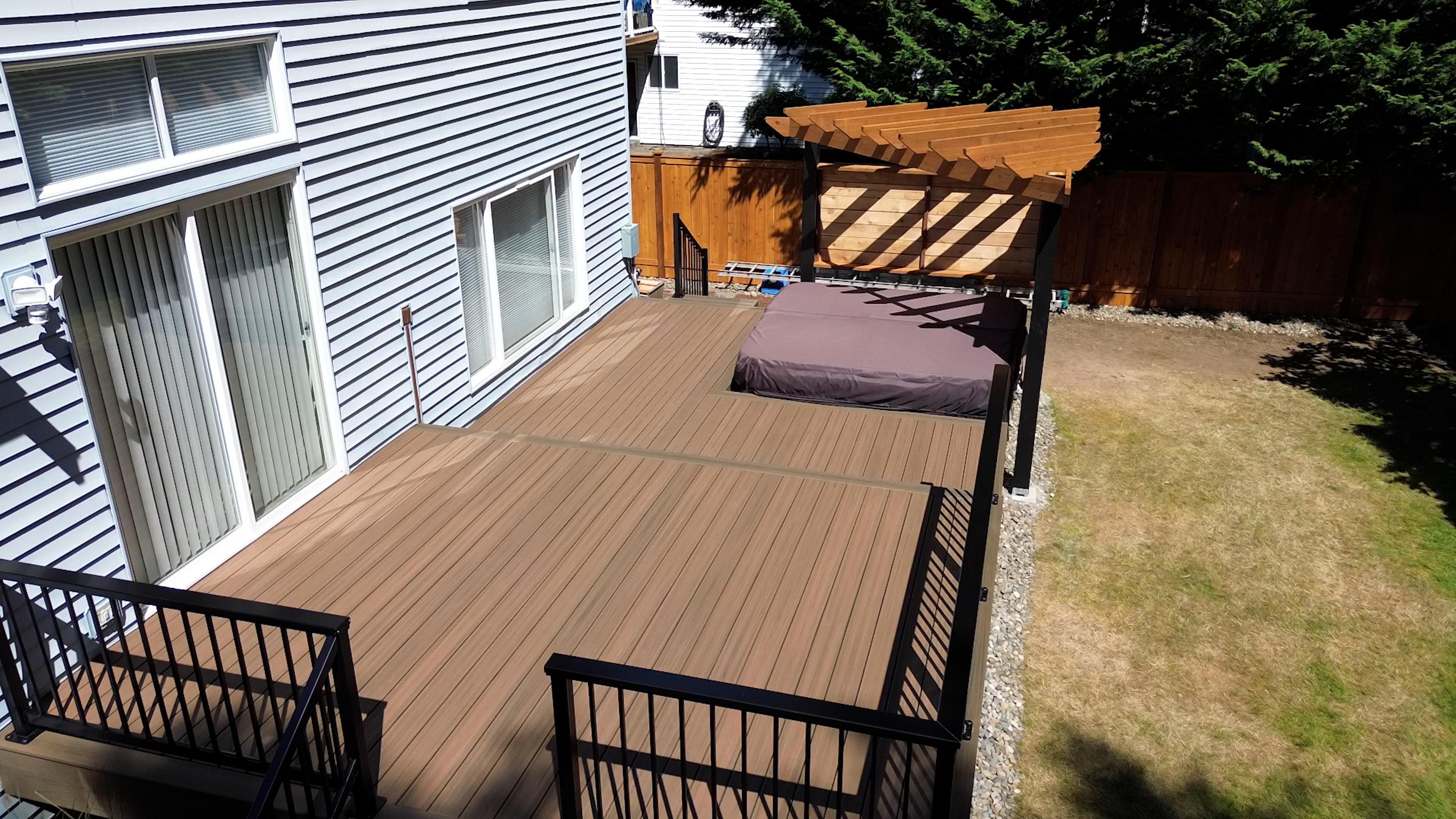 Deck with Trex Toasted Sand decking and custom pergola around hot tub
