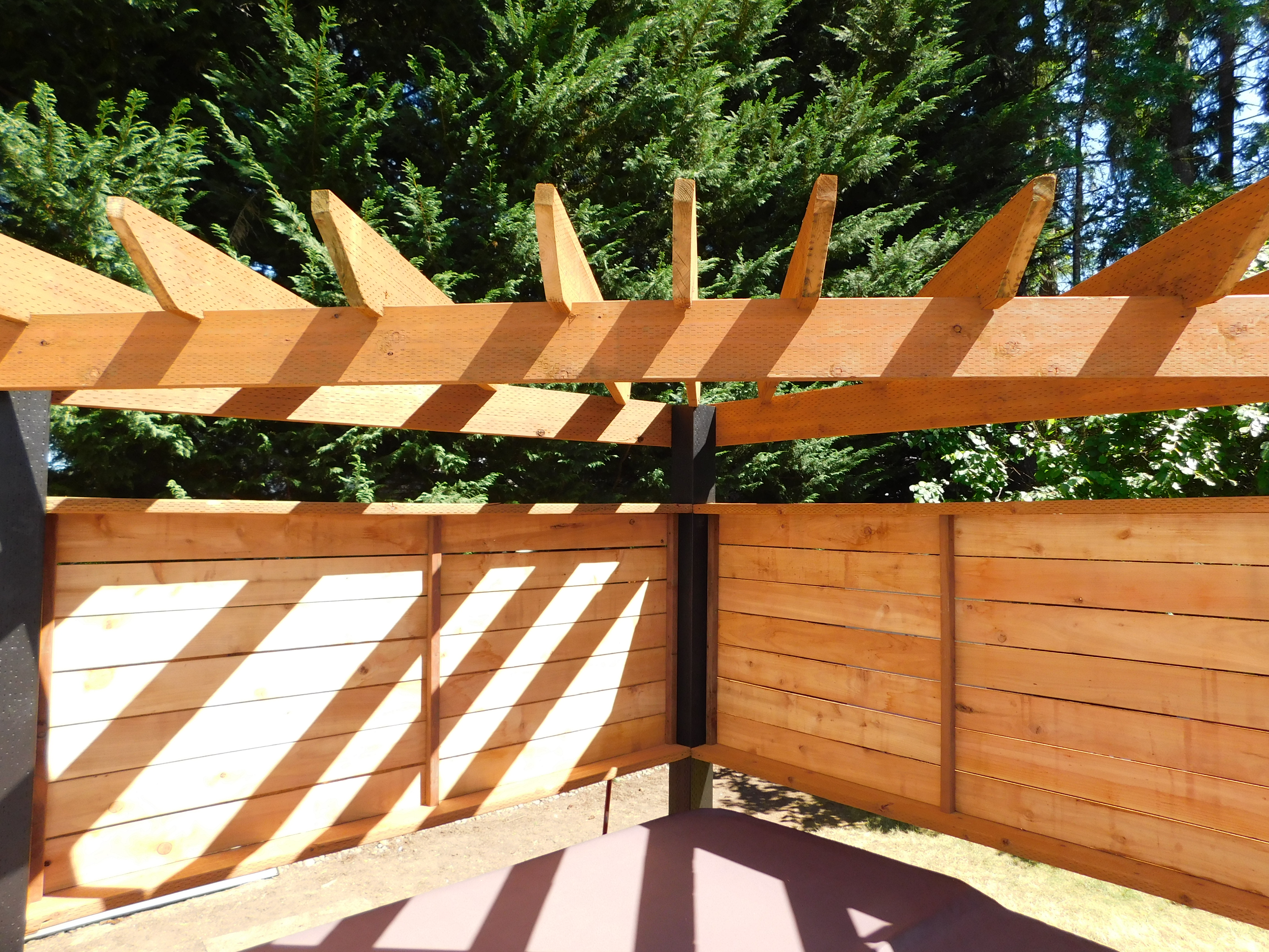 Completed Trex Toasted Sand deck with hot tub pergola and black railing