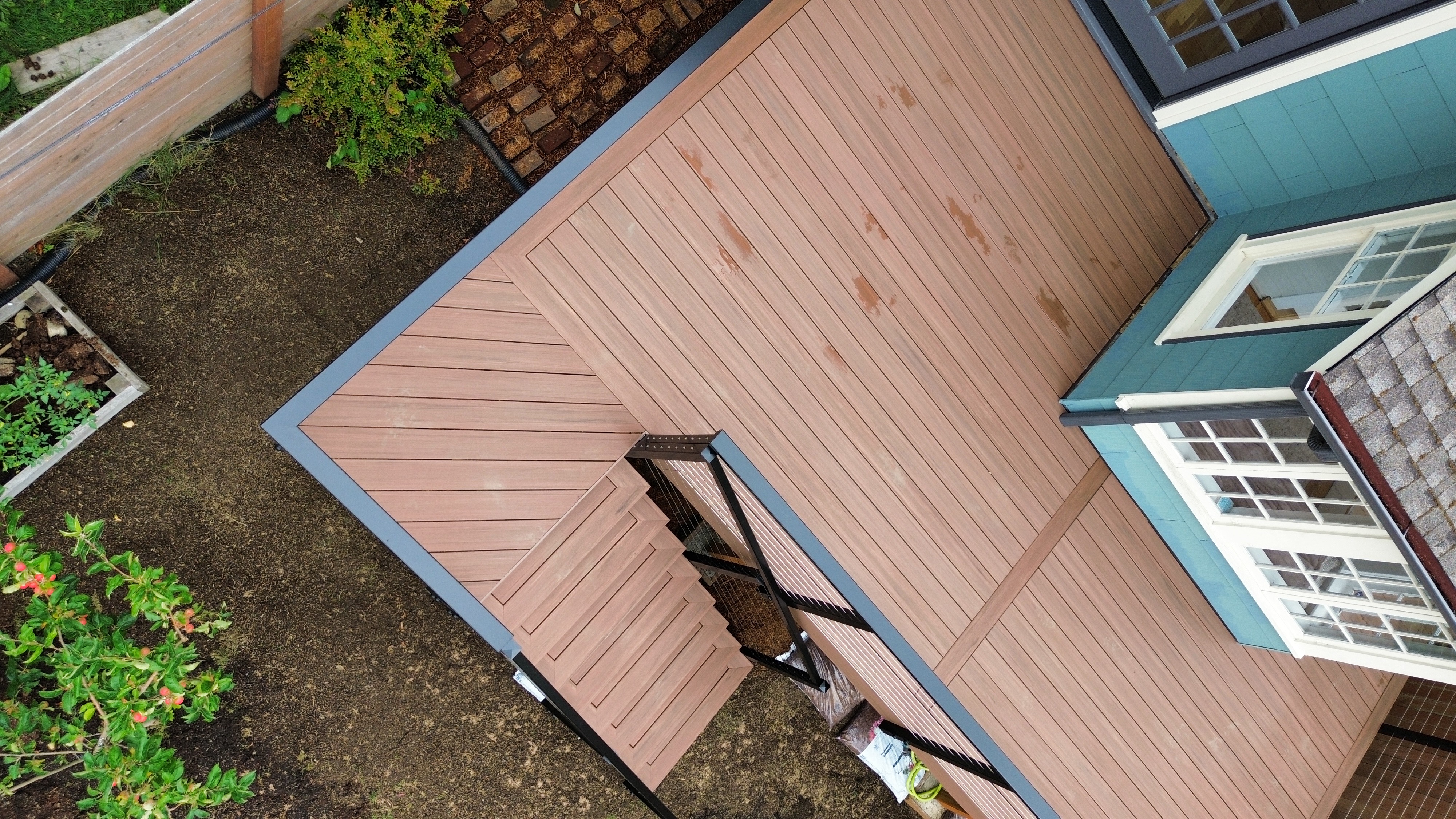 Close-up of TimberTech Mahogany PVC decking with cable railing