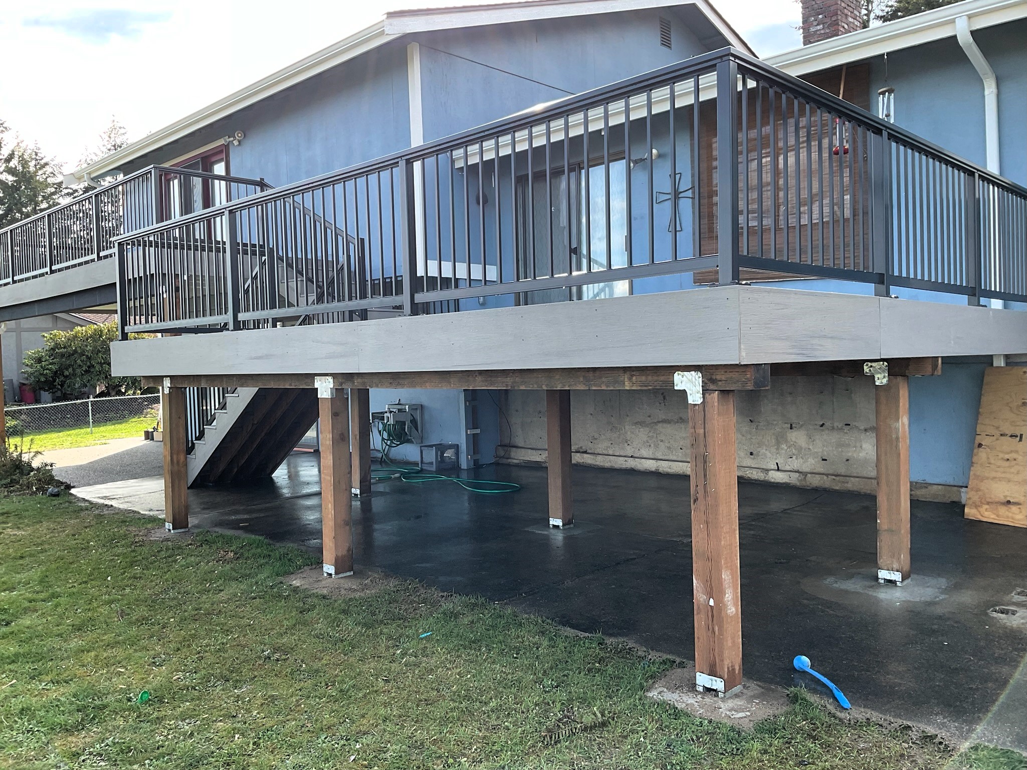 Completed TimberTech Driftwood multi-level deck with functional lower DrySpace