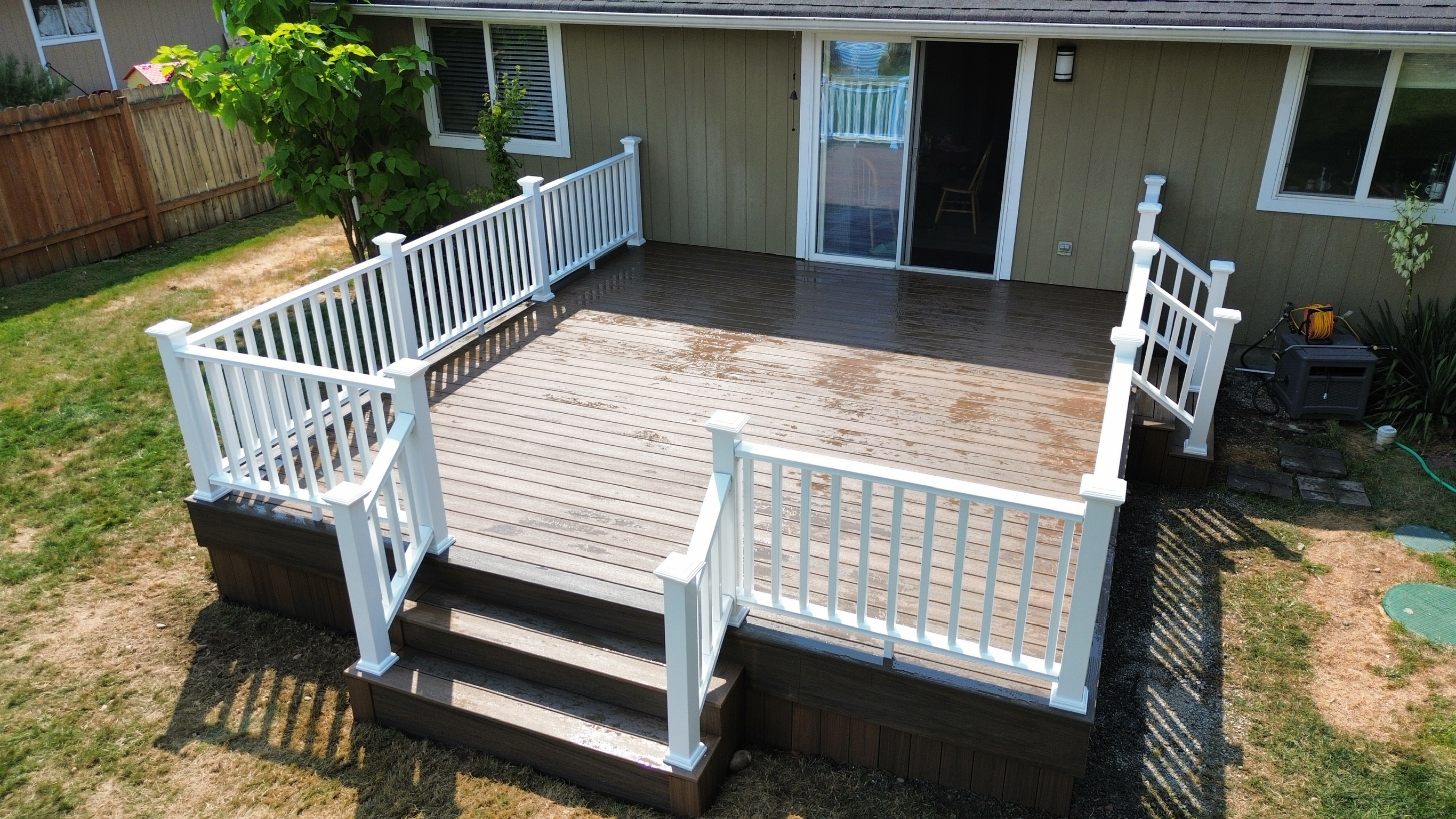 Close-up of Trex Toasted Sand decking and white composite railing