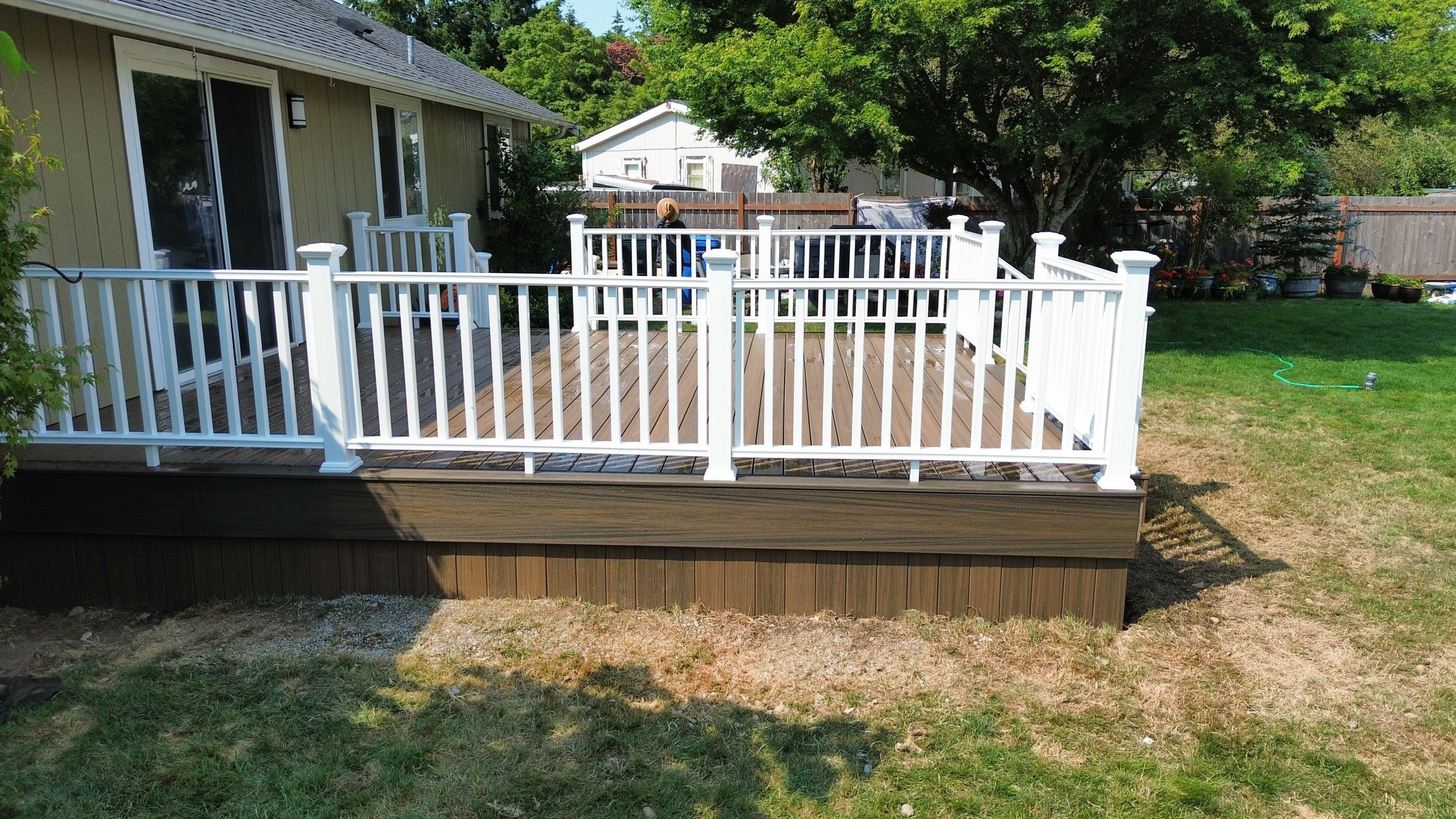Trex deck with Coastal Bluff picture-frame boards and white picket railing